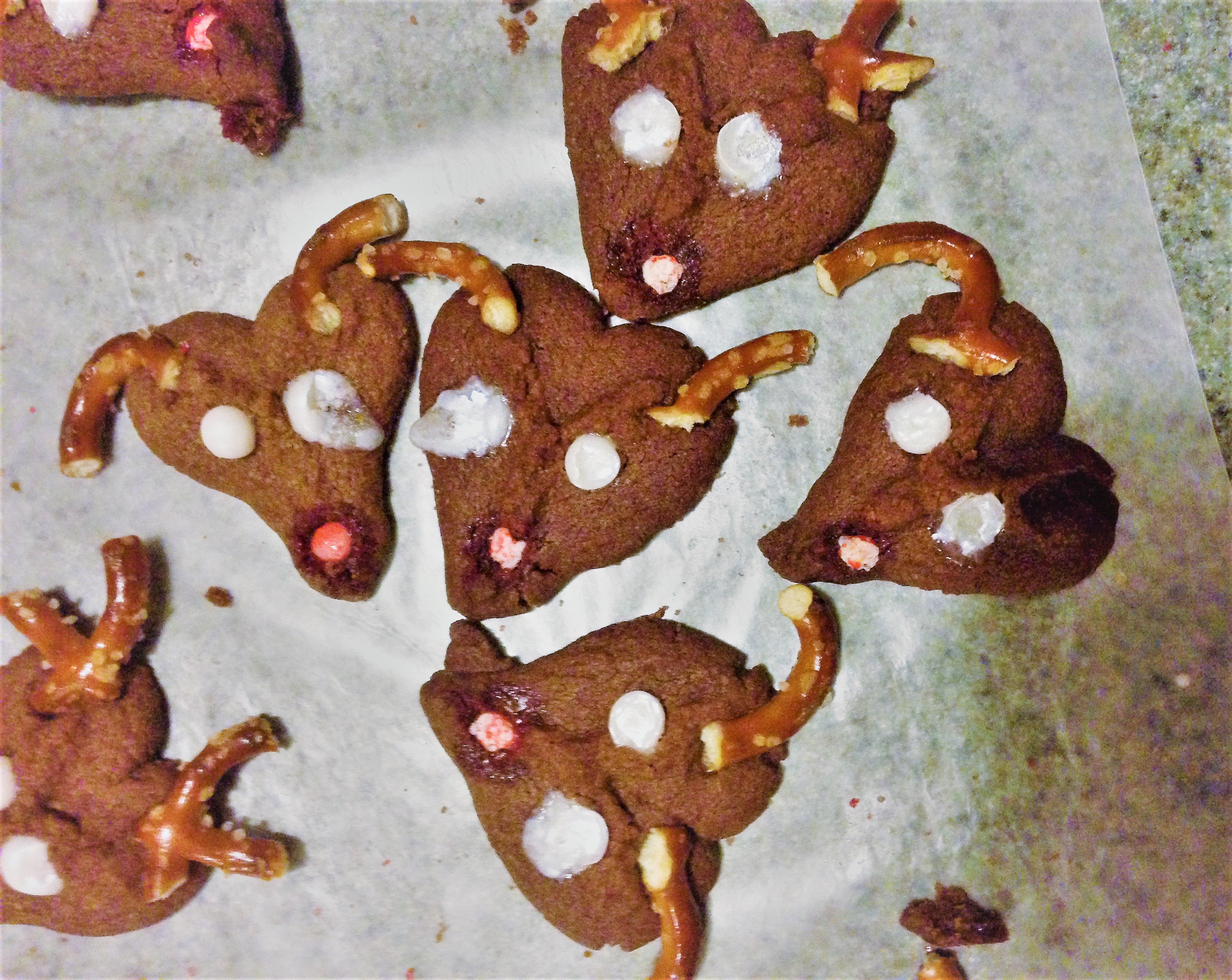 Reindeer Spritz Cookie Recipe - These cute Rudolph cookies will bring a smile to young and old at your next holiday gathering! Reindeer Spritz Cookies are made using a cookie press. Spritz is traditionally a German butter cookie or biscuit formed by squirting the dough through a shaped disc with a cookie press. Kids absolutely love to use a cookie press. 