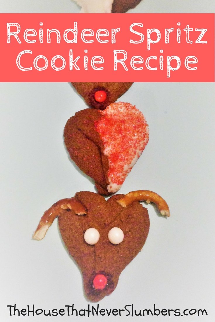 Reindeer Spritz Cookie Recipe - These cute Rudolph cookies will bring a smile to young and old at your next holiday gathering! Reindeer Spritz Cookies are made using a cookie press. Spritz is traditionally a German butter cookie or biscuit formed by squirting the dough through a shaped disc with a cookie press. Kids absolutely love to use a cookie press. 