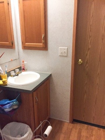 before photo of my small bathroom before I refinished the cabinets to grey with white marble countertops