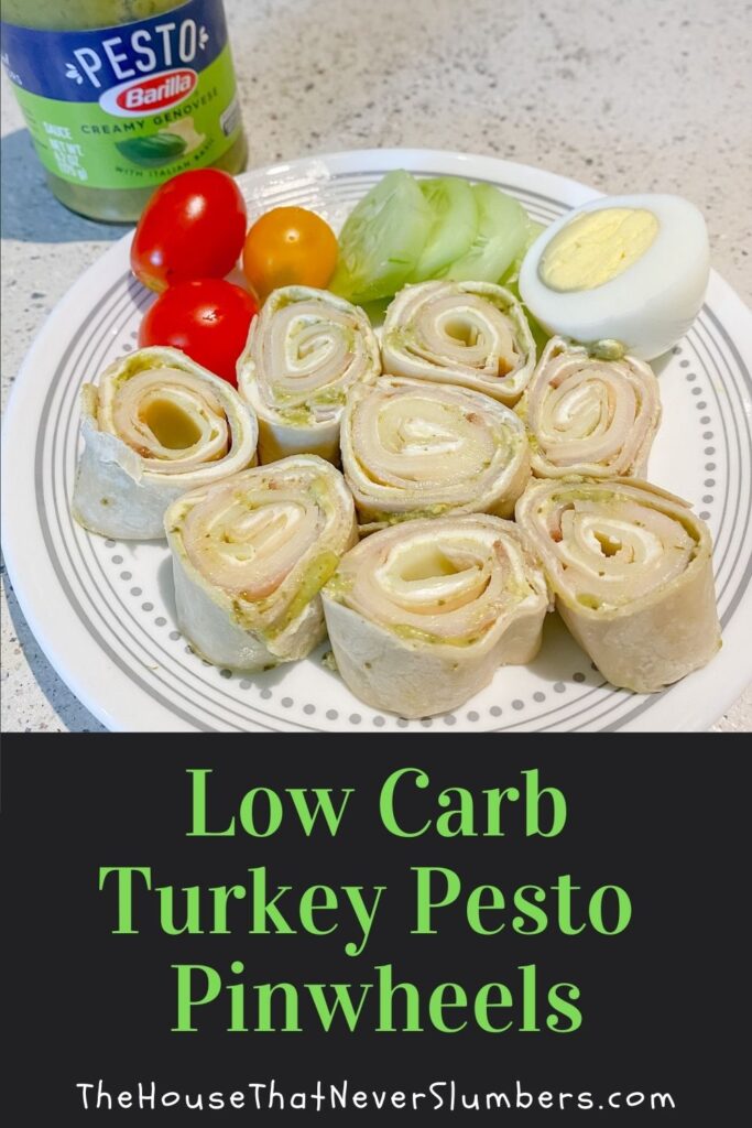Low Carb Turkey Pesto Pinwheels on a plate with vegetables and boiled eggs
